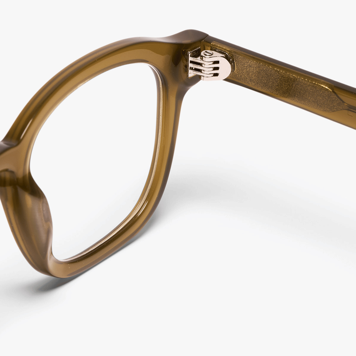 Shiny olive glasses frame close-up with gold hinge detail