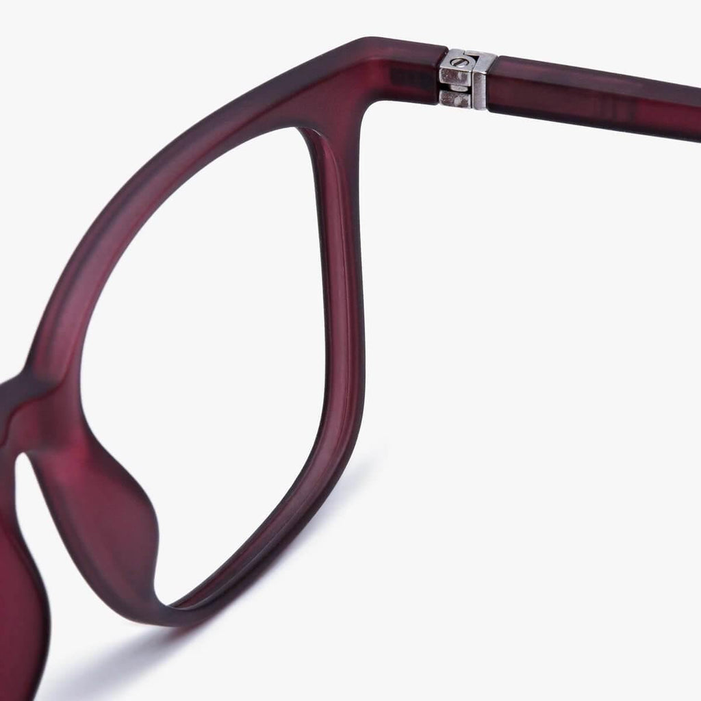 Close-up view of the hinge and frame detail of Riley Red Reading glasses with maroon frames, highlighting the quality craftsmanship and sleek design.